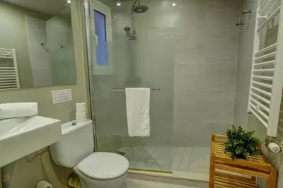 a bathroom with a shower and a toilet and a sink at La Gioia 3 by Hello Homes Sitges in Sitges