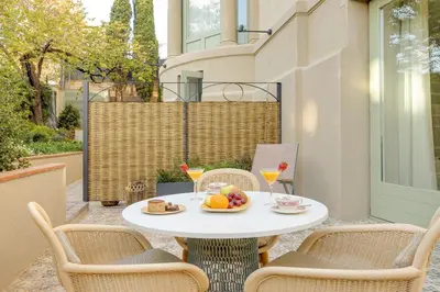a table with a bowl of fruit on a patio at Hotel Boutique Mirlo Barcelona in Barcelona