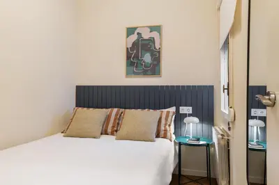 a bedroom with a bed and a painting on the wall at Rafael Apartment by Olala Homes in Hospitalet de Llobregat