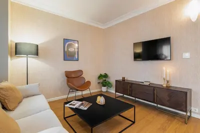 a living room with a couch and a tv at Rafael Apartment by Olala Homes in Hospitalet de Llobregat