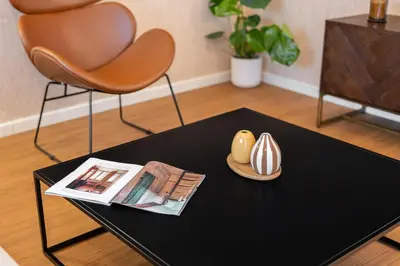 a coffee table with a magazine and a shell on it at Rafael Apartment by Olala Homes in Hospitalet de Llobregat