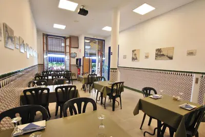 a restaurant with tables and chairs in a room at Hotel Tres Leones in Vilassar de Mar