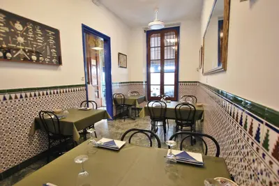 a restaurant with tables and chairs in a room at Hotel Tres Leones in Vilassar de Mar