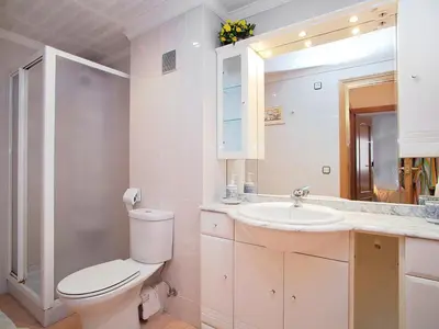 a bathroom with a toilet and a sink and a mirror at Apartment Edificio Blanqueries by Interhome in Calella