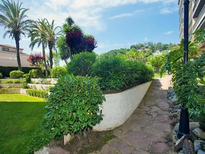 a large stone planter with plants in a garden at Apartment Edificio Blanqueries by Interhome in Calella