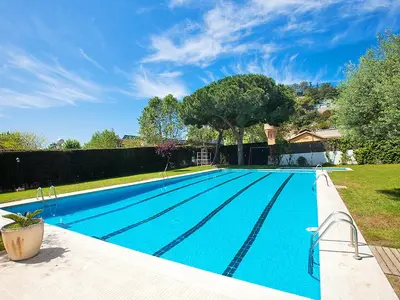 a large blue swimming pool in a yard at Apartment Edificio Blanqueries by Interhome in Calella