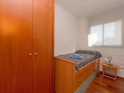 a bedroom with a bed and a wooden cabinet at Apartment Poblenou by Interhome in Barcelona