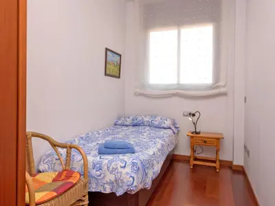 a small bedroom with a bed and a window at Apartment Poblenou by Interhome in Barcelona