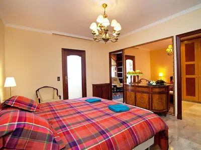 a bedroom with a large bed with a plaid blanket at Apartment Pg Gracia - Valencia by Interhome in Barcelona