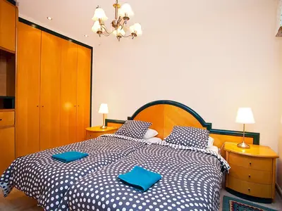 a bedroom with a large bed with blue pillows at Apartment Pg Gracia - Valencia by Interhome in Barcelona