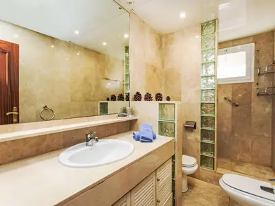 a bathroom with a sink and a toilet and a mirror at Apartment Sants-Les Corts Galileu by Interhome in Barcelona