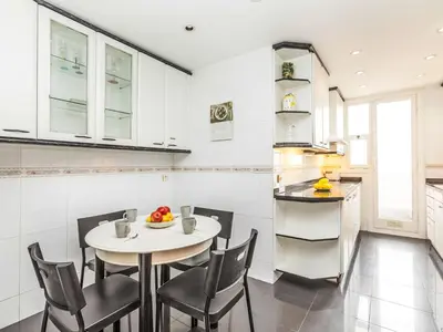 a kitchen with a table and chairs in a kitchen at Apartment Sants-Les Corts Galileu by Interhome in Barcelona