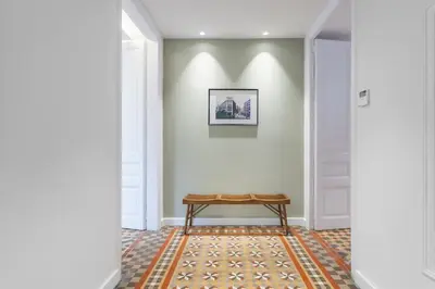 a hallway with a table on a rug at Flateli Pelayo H5 in Barcelona