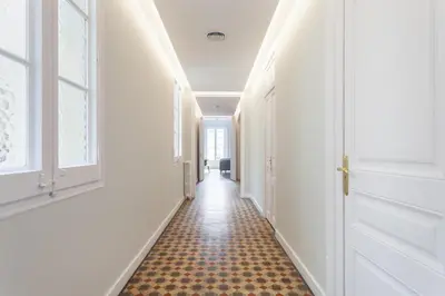 a hallway with white walls and an orange floor at Flateli Pelayo H5 in Barcelona
