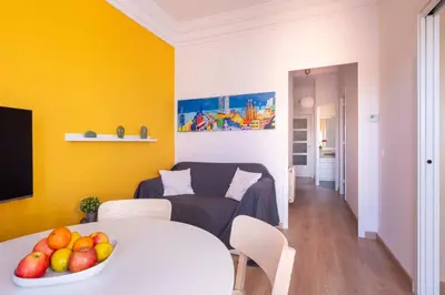 a living room with a table with a bowl of fruit at Sunny Apt Barcelona 22 in Barcelona