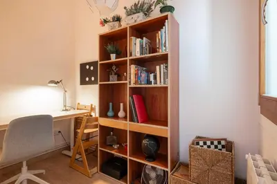 a room with a desk and a book shelf at Sunny Apt Barcelona 22 in Barcelona