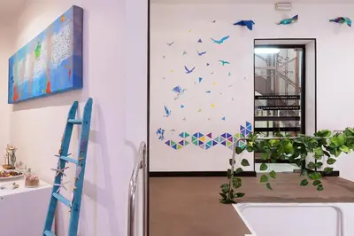 a room with blue butterflies on the wall at Amra Barcelona Caspe in Barcelona