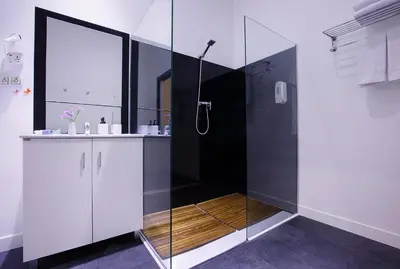 a bathroom with a shower with a glass door at Amra Barcelona Caspe in Barcelona