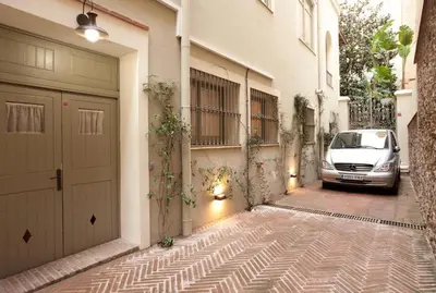 a car parked next to a building with a garage at Romantic In Trendy Gracia in Barcelona