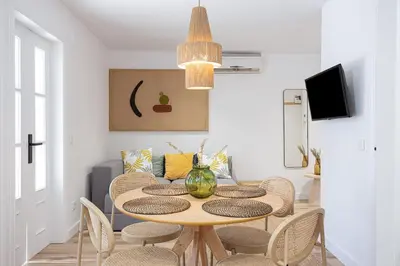 a dining room with a table and chairs at Walk To Las Ramblas Sun-filled&cozy in Barcelona