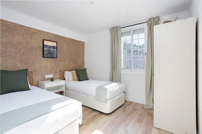 a hotel room with two beds and a window at Walk To Las Ramblas Sun-filled&cozy in Barcelona