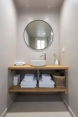 a bathroom with a sink and a mirror at Walk To Las Ramblas Sun-filled&cozy in Barcelona