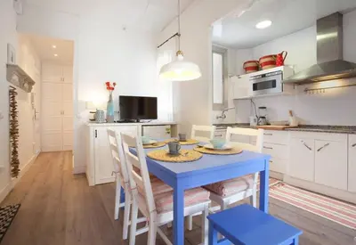a kitchen with a blue table and some chairs at Apt In 22 Close To The Beach in Barcelona