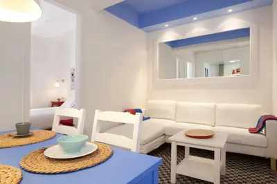 a living room with a white couch and chairs at Apt In 22 Close To The Beach in Barcelona