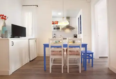 a kitchen with a blue table and chairs in a room at Apt In 22 Close To The Beach in Barcelona