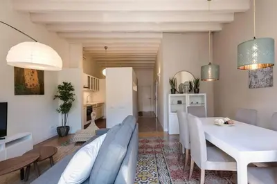 a living room with a white table and chairs at Historical Apartment With Awesome Rooftop in Barcelona