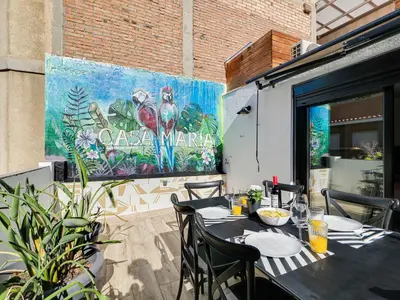 a black table and chairs on a patio at Casa Maria Townhouse- terrace-4 bedrooms in Hospitalet de Llobregat