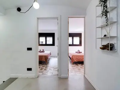 a white room with a table and a room with a bed at Casa Maria Townhouse- terrace-4 bedrooms in Hospitalet de Llobregat
