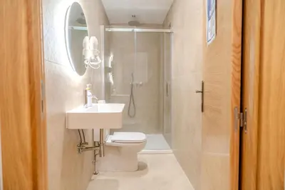 a bathroom with a toilet and a sink and a shower at HolidaysBCN Rooms in Barcelona