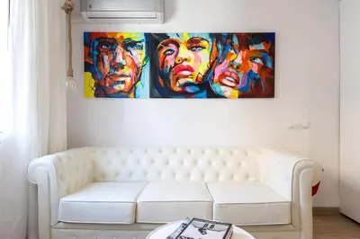 a living room with a white couch and paintings on the wall at Besos Beach Gem 1 By MyRentalHost in Sant Adria de Besos
