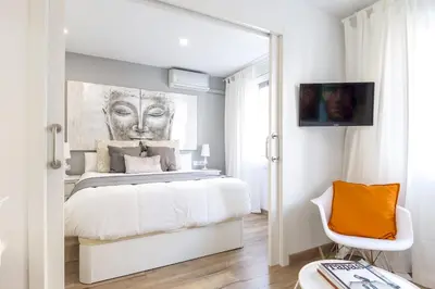 a bedroom with a bed and a painting on the wall at Besos Beach Gem 1 By MyRentalHost in Sant Adria de Besos