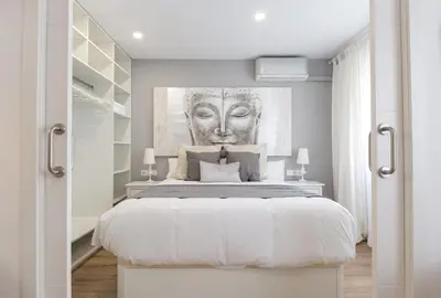 a bedroom with a large bed with a painting on the wall at Besos Beach Gem 1 By MyRentalHost in Sant Adria de Besos