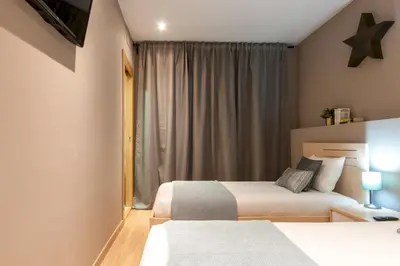 a bedroom with two beds and a window at Casa PILAR Central By MyRentalHost in Barcelona