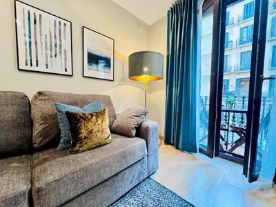 a living room with a couch and a window at Casa PILAR Central By MyRentalHost in Barcelona