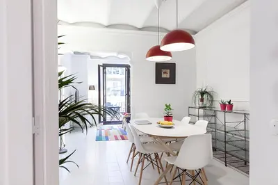 a white dining room with a white table and white chairs at Sagrada Familia ART Apt By MyRentalHost in Barcelona
