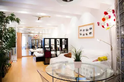a living room with a glass table and a couch at Studio Gracia By MyRentalHost in Barcelona