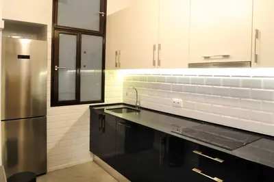 a kitchen with a sink and a refrigerator at Architects Home By MyRentalHost in Barcelona