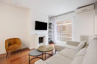 a living room with a couch and a fireplace at Live Like A Local In Bcn in Barcelona