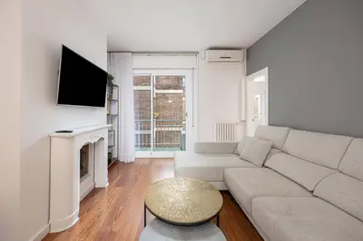 a living room with a couch and a tv at Live Like A Local In Bcn in Barcelona