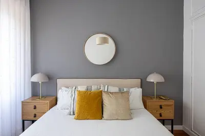 a bedroom with a white bed with yellow pillows at Live Like A Local In Bcn in Barcelona