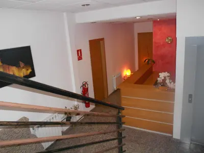 a living room with a staircase and a stair case at Hostal Ca La Irene in San Vicente de Castellet