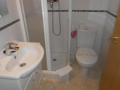 a bathroom with a shower and a toilet and a sink at Hostal Ca La Irene in San Vicente de Castellet