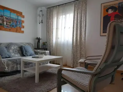 a living room with a couch and a table at Cozy Apartment Near The Beach in Barcelona