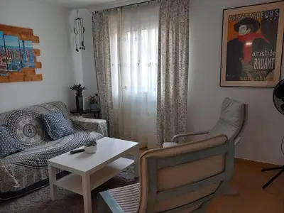 a living room with a couch and a table at Cozy Apartment Near The Beach in Barcelona