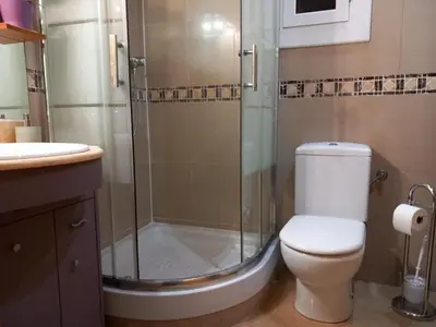 a bathroom with a shower and a toilet and a sink at Cozy Apartment Near The Beach in Barcelona