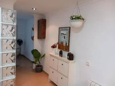 a room with a dresser and a mirror on a wall at Cozy Apartment Near The Beach in Barcelona
